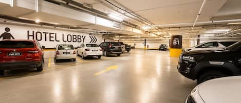 A multi-level parking garage with a sign for 'HOTEL LOBBY' and a 'LEVEL B1' sign.