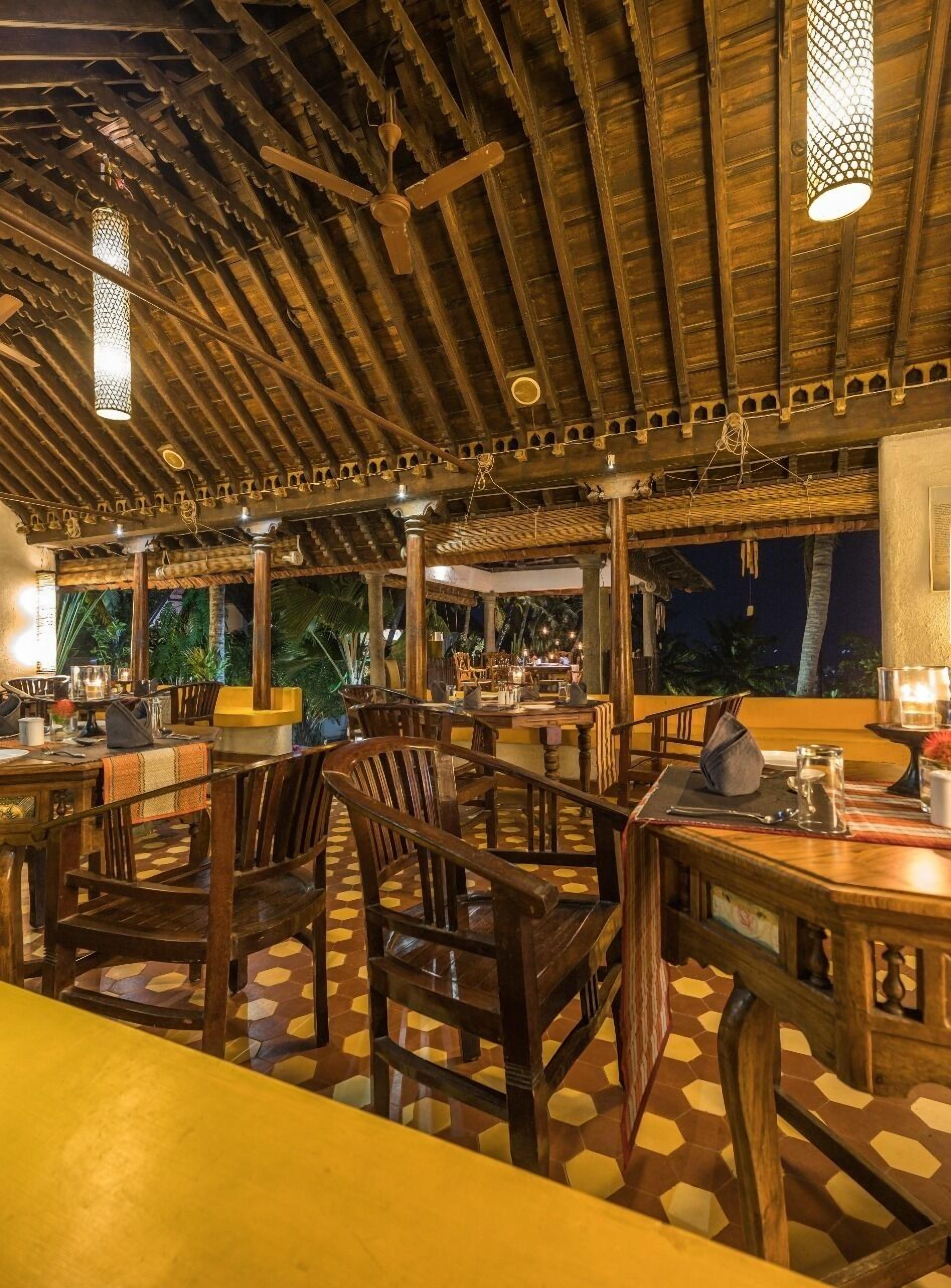 An indoor dining area with wooden furniture and a checkered floor pattern.