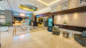 A spacious lobby with a reception desk, seating area, and a restaurant named "ITALIAN KITCHEN". - Copthorne Downtown Abu Dhabi (Abu Dhabi)