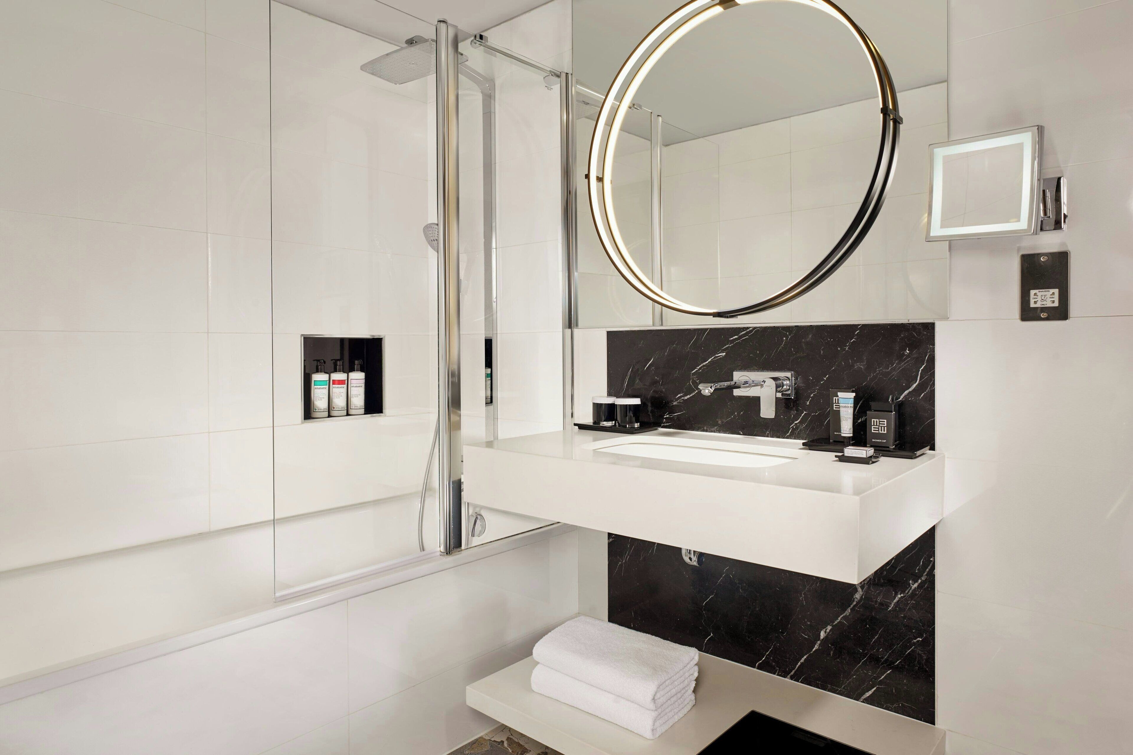 junior suite, 1 double bed (view) | bathroom | combined shower/bathtub, rainfall showerhead, designer toiletries