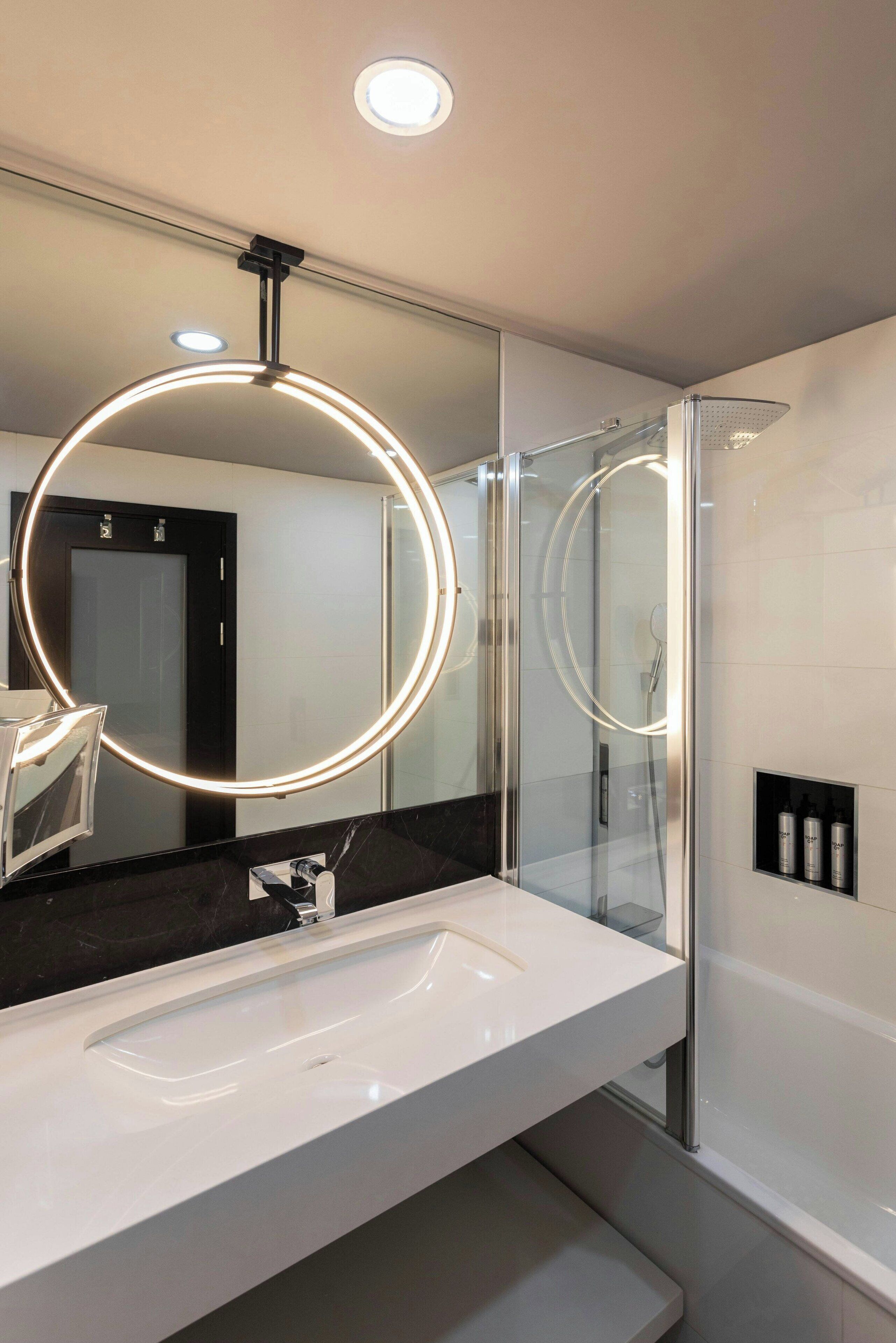 junior suite, non smoking | bathroom | combined shower/bathtub, rainfall showerhead, designer toiletries