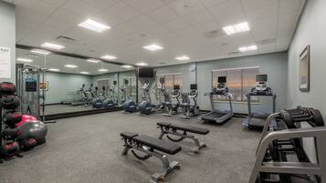 A gym with exercise equipment, treadmills, and weight machines.