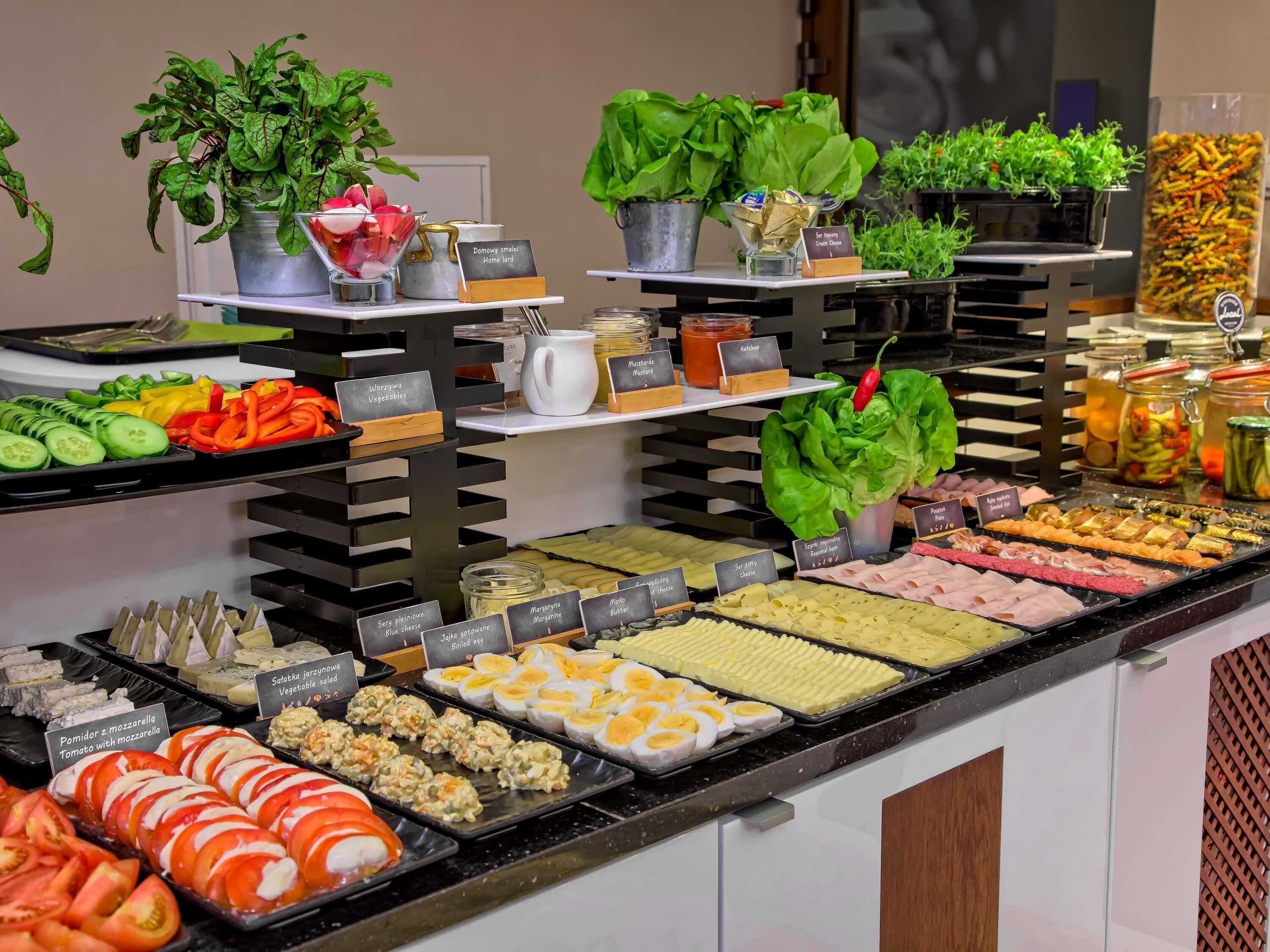 Buffet amb diverses opcions gastronòmiques, com ara verdures, carns, formatges i amanides.
