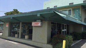 A building with a 'Lobby' sign, a 'No Parking' sign, and a 'Closed to the Public' sign. - Travel Inn (North Hills)