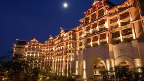 A multi-story hotel with traditional architectural design, featuring balconies and arched windows. - Haikou Marriott Hotel (Haikou)