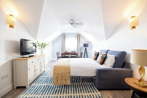 A bedroom with a bed, a TV, a desk, and a chair. - SACO Jersey Merlin House (St. Helier)