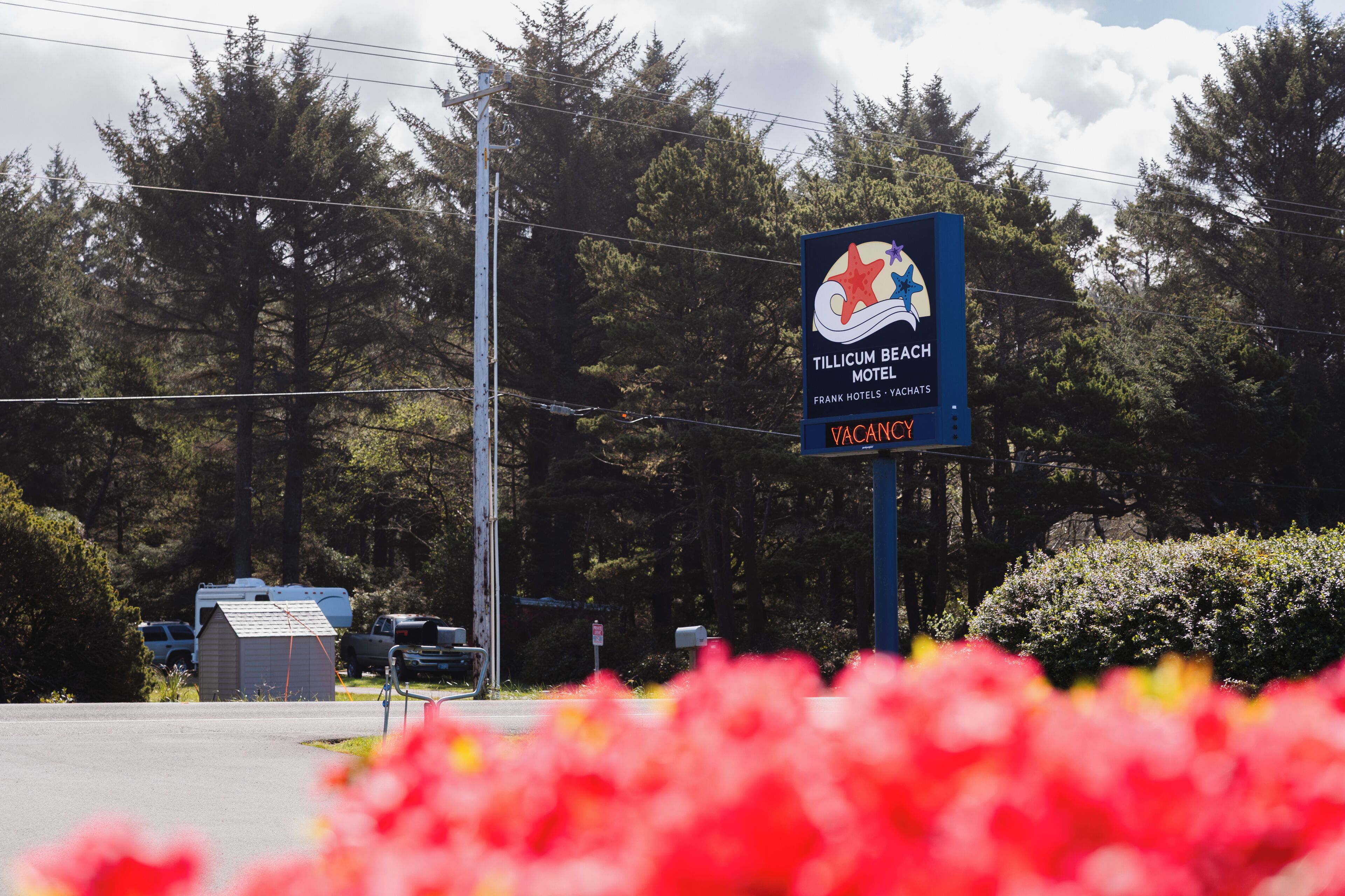 A sign for Tillicum Beach Motel with a starfish logo, indicating a beach location.