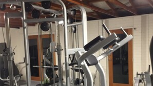A gym with various exercise equipment, including weight machines and free weights.