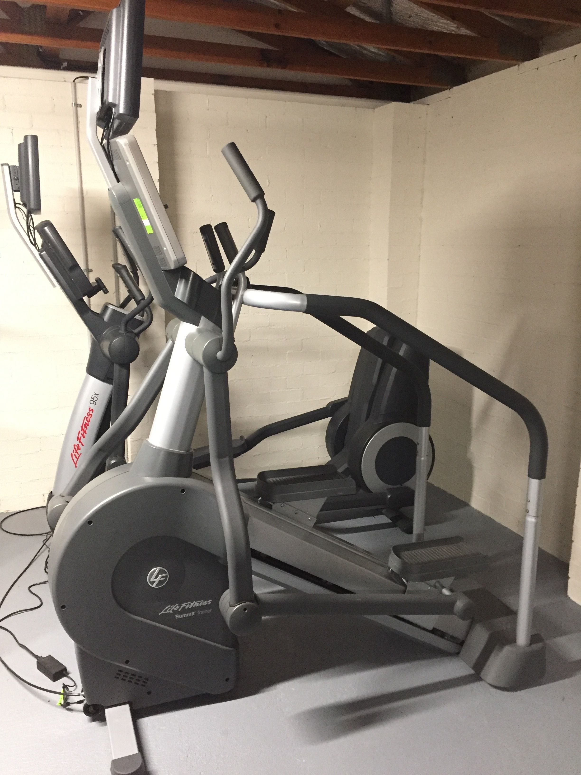 A stationary bike with a display screen and a handlebar.