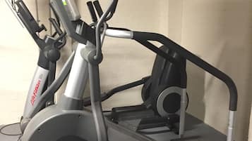 A stationary bike with a display screen and a handlebar.