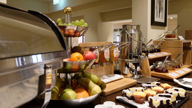 Ein reichhaltiges Buffet mit verschiedenen Früchten, Gebäck und Beilagen.