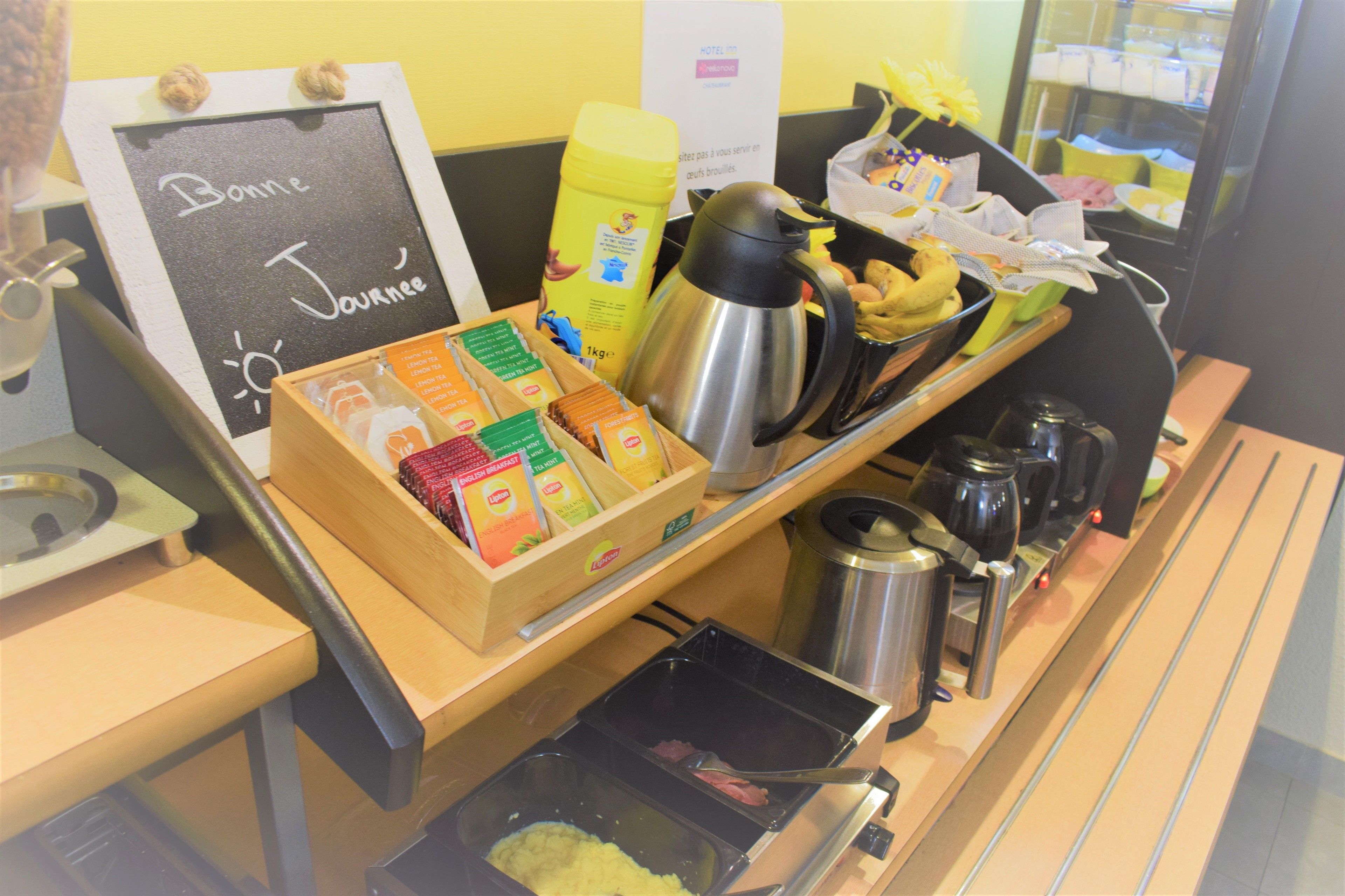 A breakfast buffet with various food items and a coffee station.