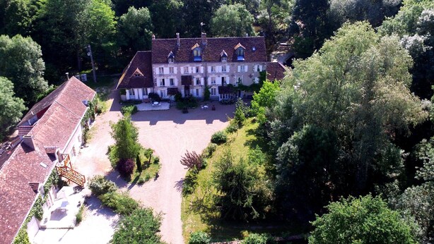 An aerial view of a large, multi-story building with a symmetrical facade, surrounded by lush greenery and a spacious courtyard. - Le Moulin du Bas Pesé (Mont-pres-Chambord)