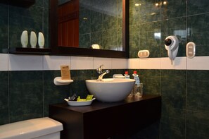 A bathroom with a large sink, a mirror, and a hand dryer. - Hosteria Durán (Banos)