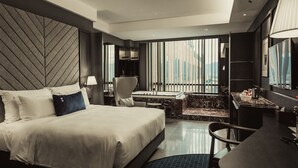 A modern hotel room with a large bed, a seating area with a view, and a dining space. - WEIL Hotel (Ipoh)