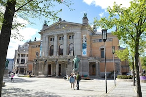 A historic building with a prominent statue in front, labeled "NATIONALTHEATER."
