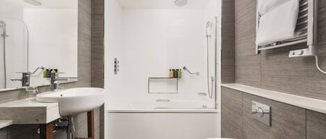 A modern bathroom with a bathtub, a toilet, and a sink.