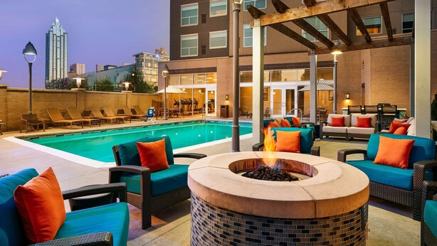 A rooftop pool area with lounge chairs and a fire pit. - Hyatt House Atlanta Downtown (Atlanta)