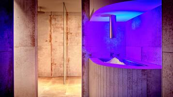 A modern bathroom with a glass shower enclosure and a wooden vanity with a built-in sink.