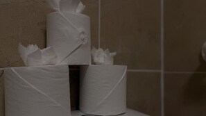 A roll of toilet paper on a dispenser. - Waverley Guest House (Inverness)