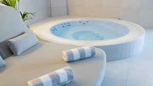 A spa area with a hot tub, a cushioned seating area, and a towel. - Dwór Prezydencki Boutique Hotel & SPA (Tarnow)