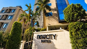 A modern building with a sign reading 'NewCity Suites'. - NewCity Hotel & Suites (New Cairo)