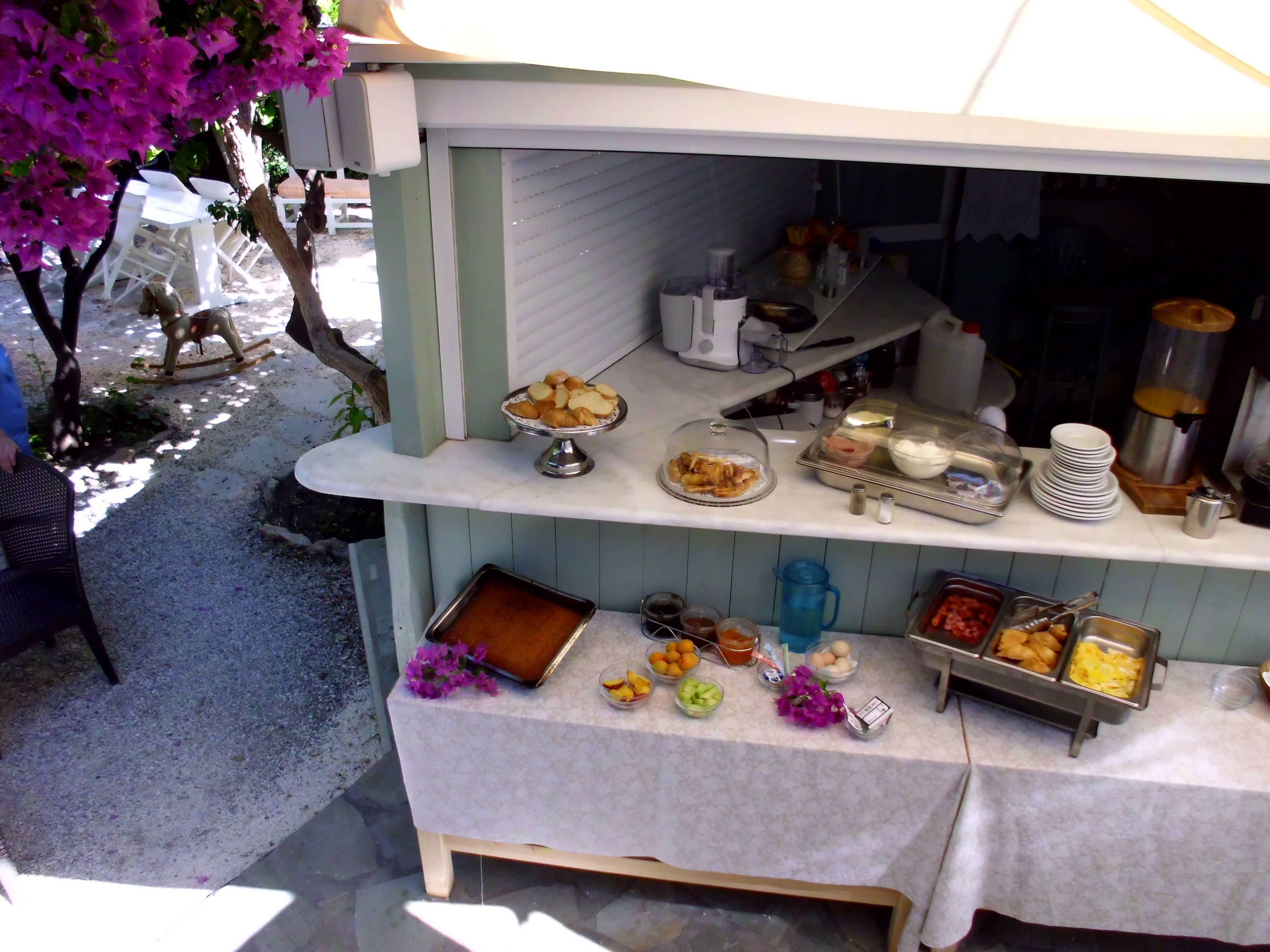 A buffet setup with various food items and condiments.