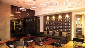 A modern interior with a seating area, a wine rack, and a bar. - Best Western Plus Panama Zen Hotel (Panama City)