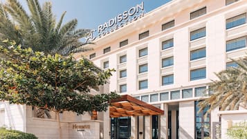 Experience the sleek entrance of the Radisson Collection, marked by a prominent sign and large windows.
