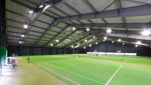 An indoor tennis court with a high ceiling and artificial lighting. - Fuji Premium Resort (Fujikawaguchiko)