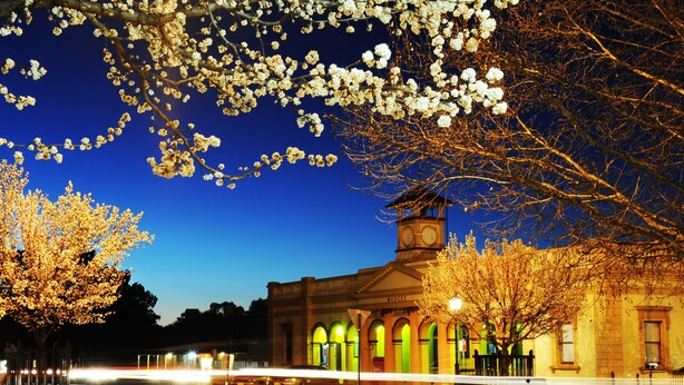 A historic building with a clock tower, arched windows, and a central courtyard. - Ningana Motel (Mudgee)