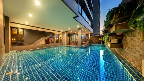 Outdoor pool, a waterfall pool, pool loungers