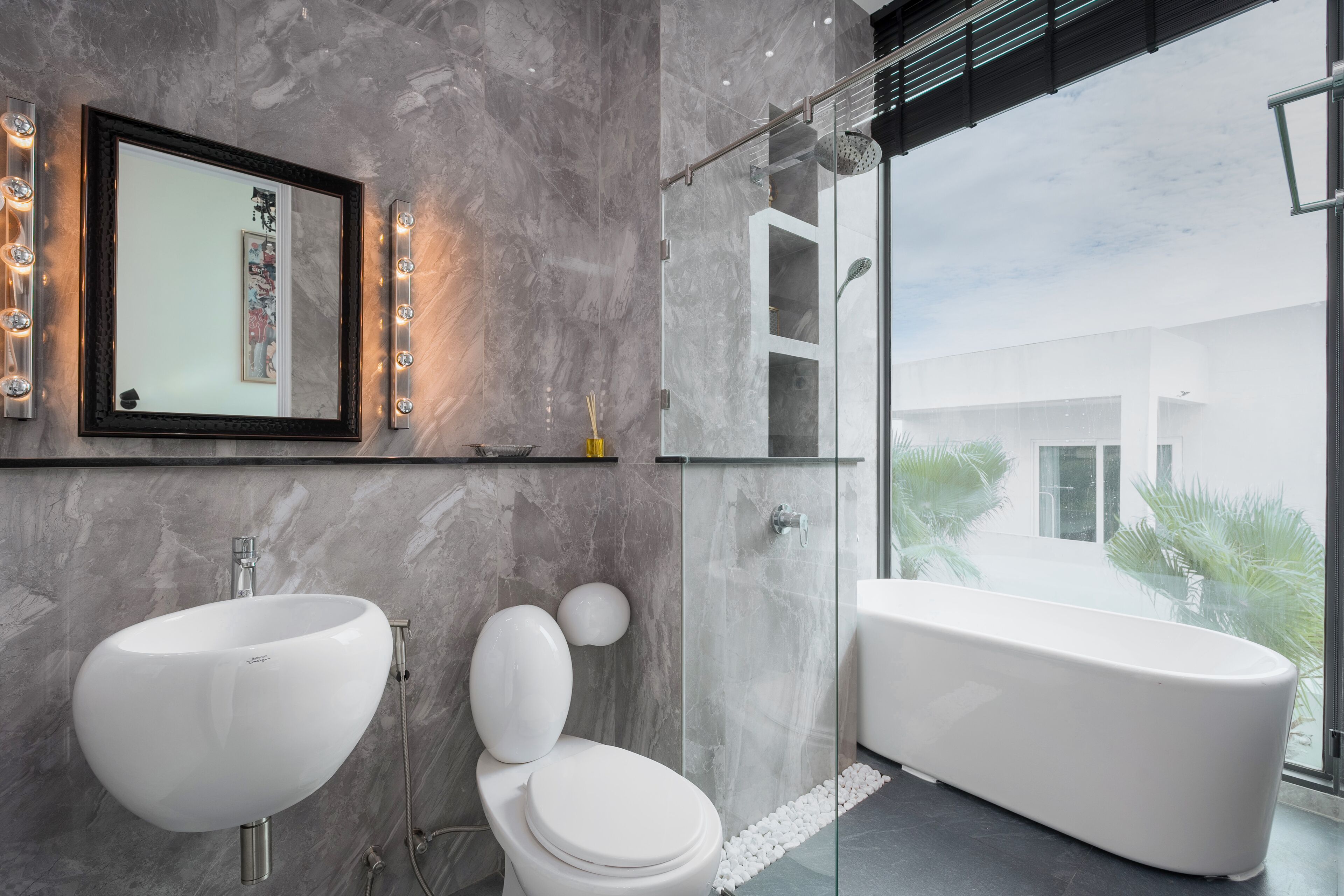 A modern bathroom with a large sink, toilet, and bathtub.