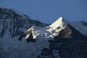 A snow-covered mountain with a prominent peak and steep slopes.