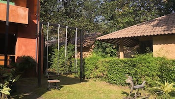 Relax in a serene garden with a swing set, surrounded by lush plants and a, enclosed space.