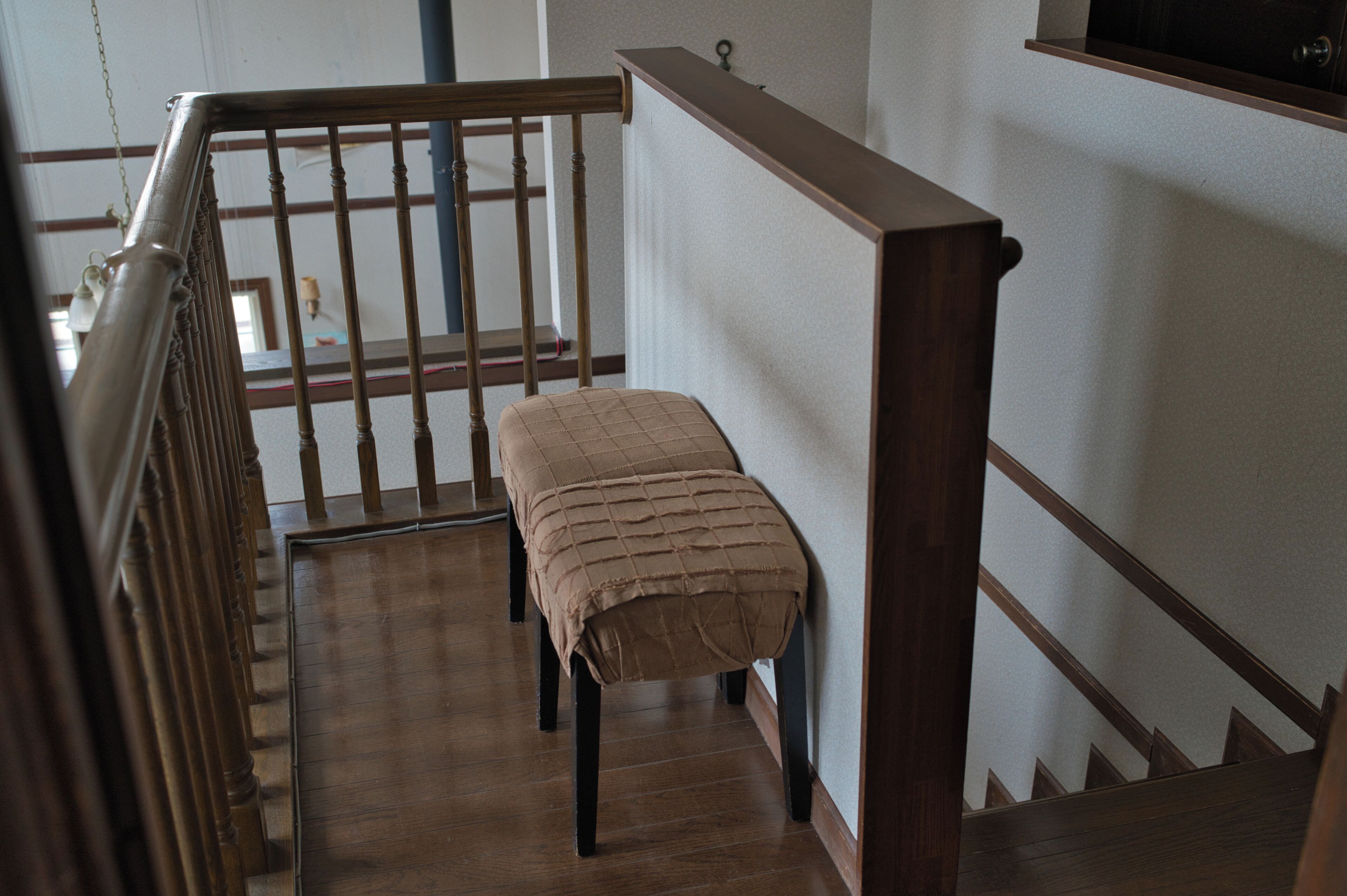 A wooden staircase with a bench at the bottom.