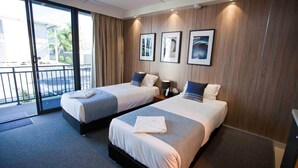 A hotel room with two beds, a balcony, and a view of the outside. - Kings Park (Chinchilla)