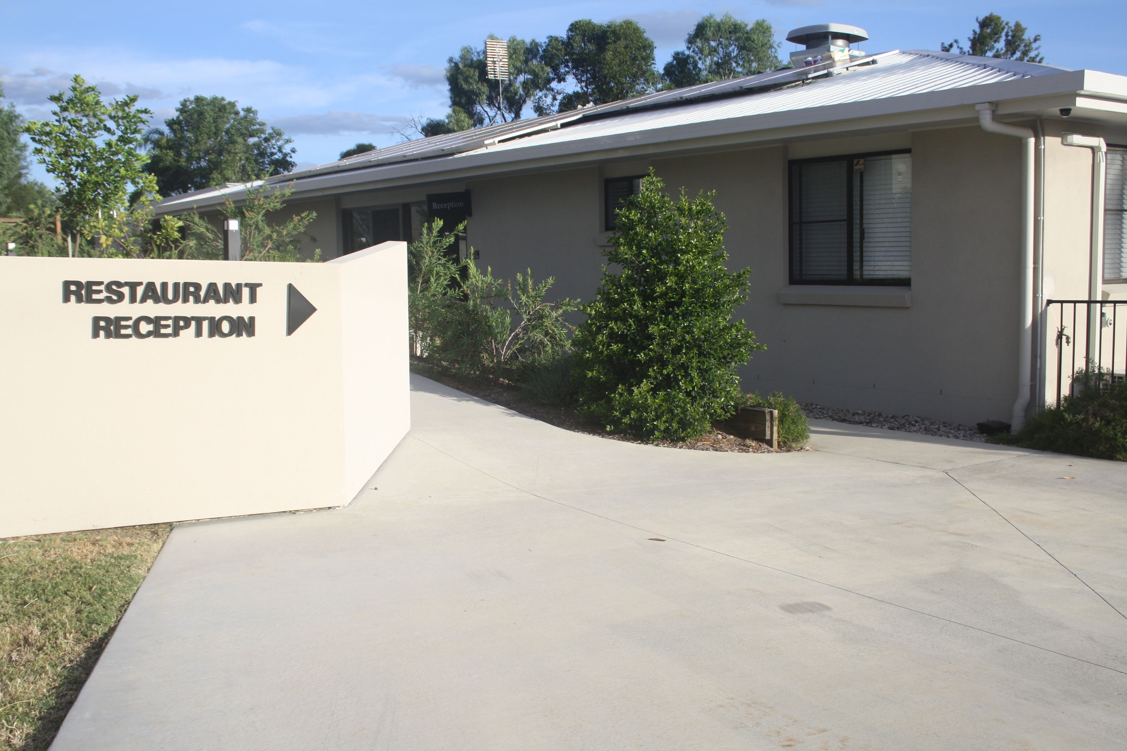 A building with a sign indicating a restaurant reception area.