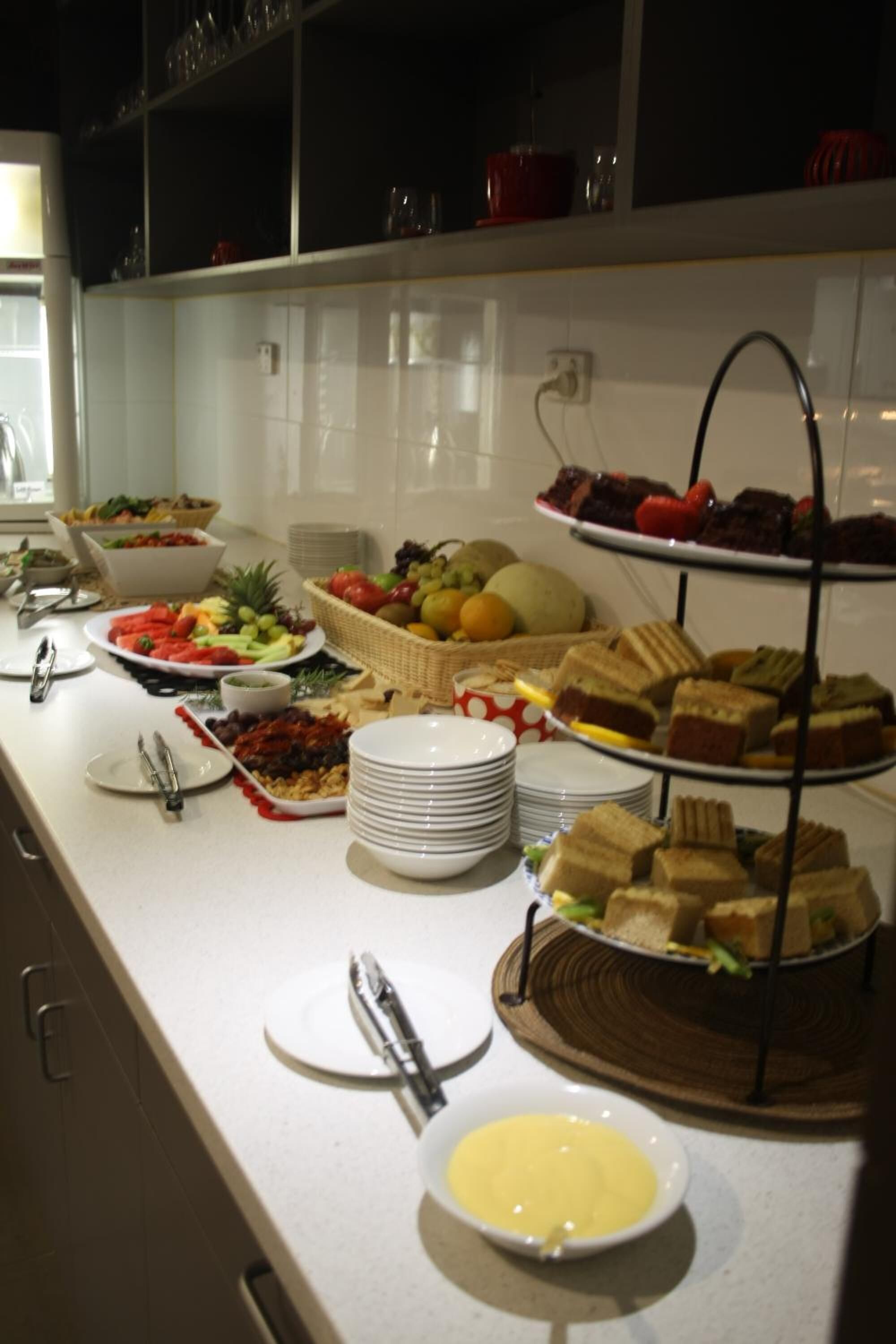 A buffet setup with various food items and utensils.