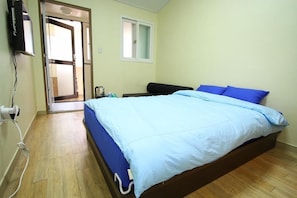 Quarto com uma cama, uma janela e uma porta.