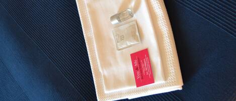 A neatly folded beige item with a red label on a dark blue fabric surface.