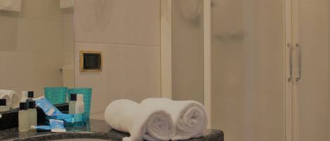 A bathroom with a sink, mirror, and towel rack.