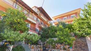 Un patio con suelo de losas de piedra, rodeado de edificios de varios pisos con balcones.