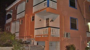 A two-story building with balconies, a flat roof, and a simple facade. - Stephanie's Apartments Ltd (Gros Islet)