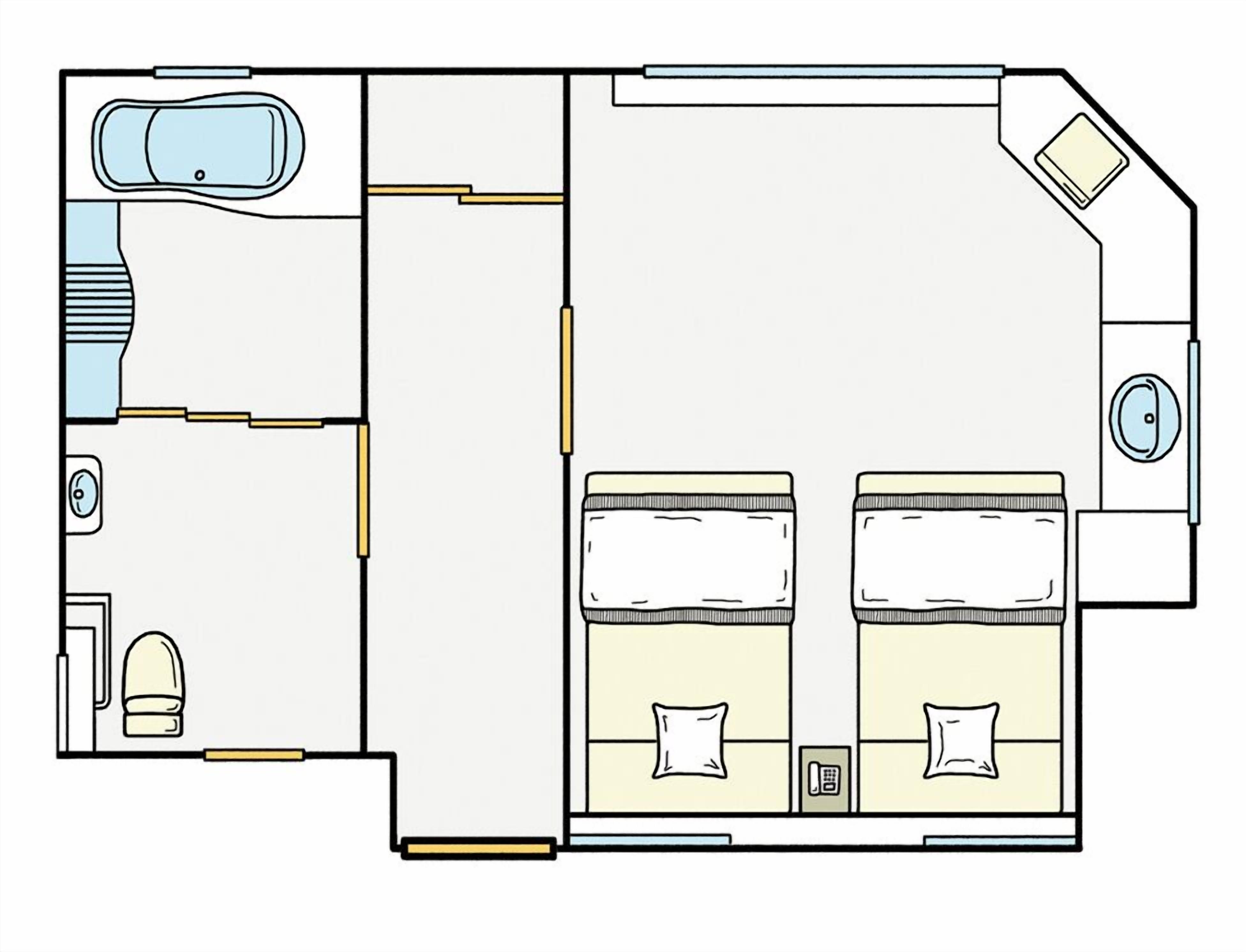 A floor plan of a hotel room with a bed, a small bathroom, a seating area, and a kitchenette.
