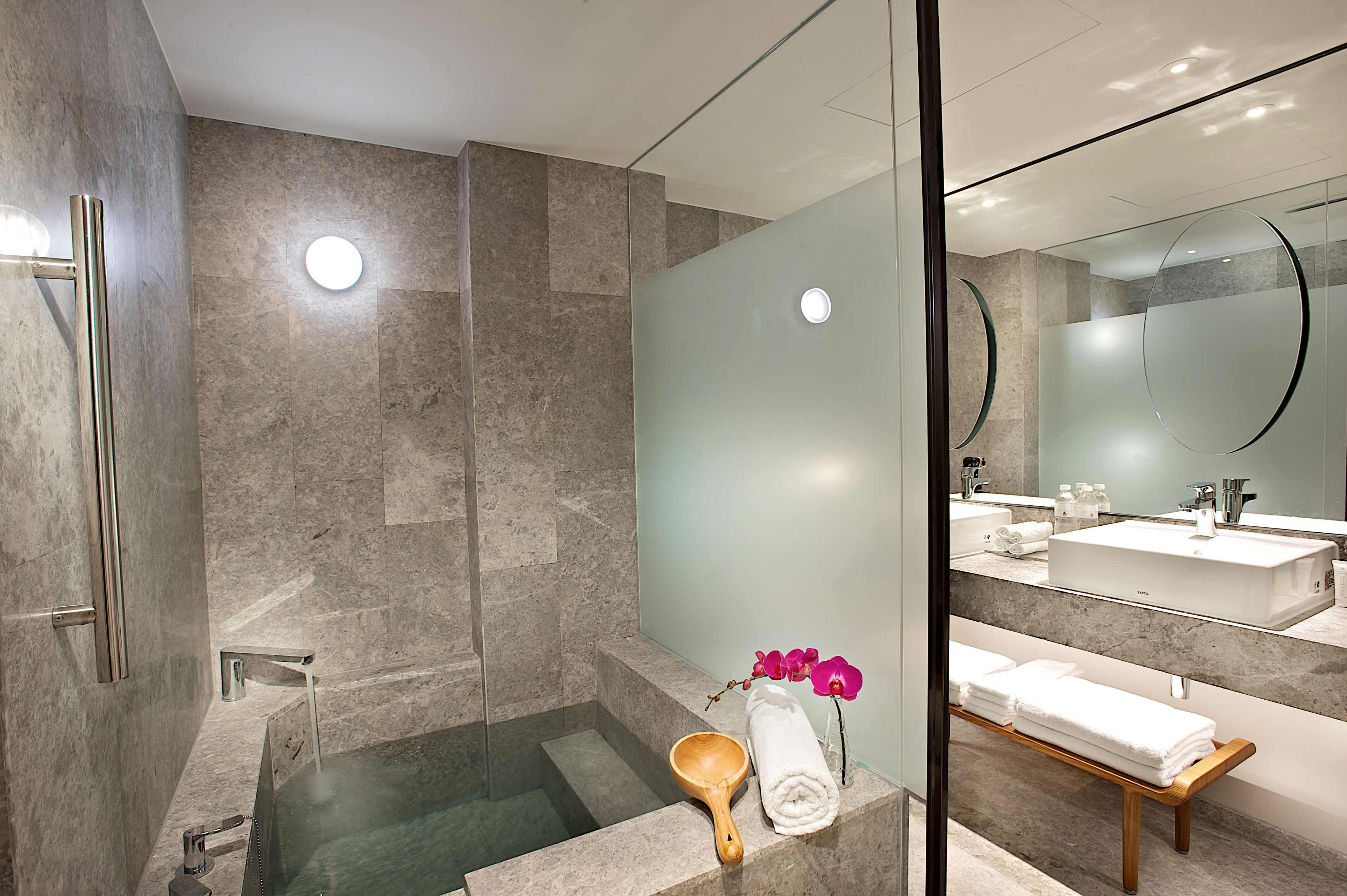 deluxe family suite | bathroom | spring water bathtub, hair dryer, slippers, bidet