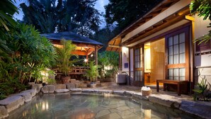 A traditional Japanese-style garden with a stone hot spring, wooden structures, and lush greenery. - Hotel Royal Chihpen (Taimali)