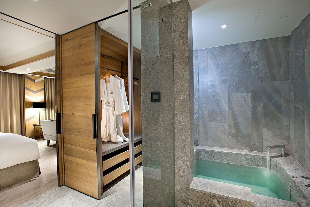 superior suite | bathroom amenities | spring water bathtub, hair dryer, slippers, bidet