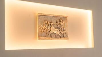 A wall-mounted sculpture of a chariot with horses and riders.