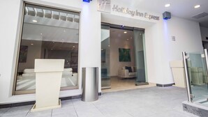 The exterior of Holiday Inn Express with a modern design, large glass windows, and a reception area visible inside. - Holiday Inn Express Xalapa by IHG (Xalapa)